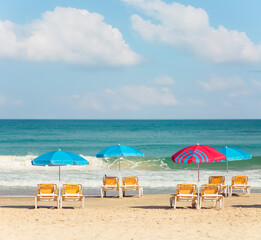 Beach umbrellas and sunbeds on the background of the sea