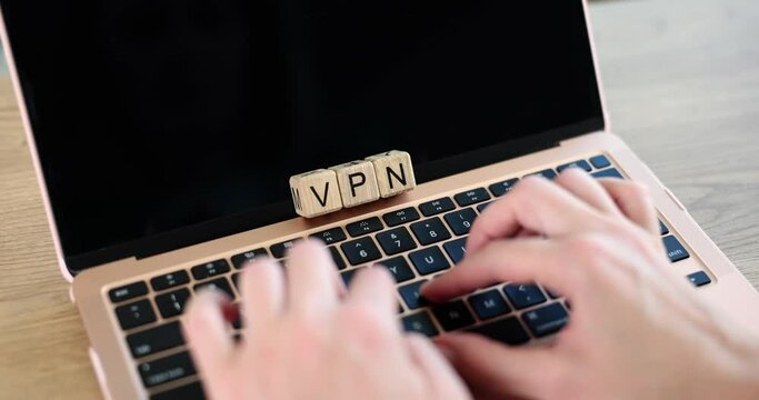VPN abbreviation and hands on laptop on desktop