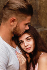 The young girl hugged her husband's shoulder