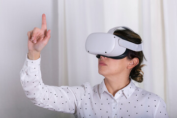 Young woman gesturing in virtual reality headset.