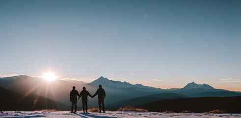 Silhouette of two person on top of mountain peak. / Holding Hands / coaching goal, success and teamwork concepts - Mountains Mountaineer / Space for Text / Blank Space / Copy Text