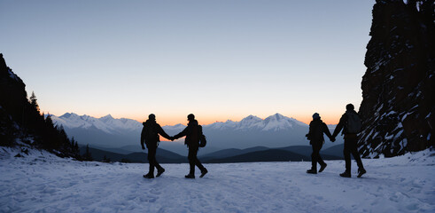 Silhouette of two person on top of mountain peak. / Holding Hands / coaching goal, success and teamwork concepts - Mountains Mountaineer / Space for Text / Blank Space / Copy Text