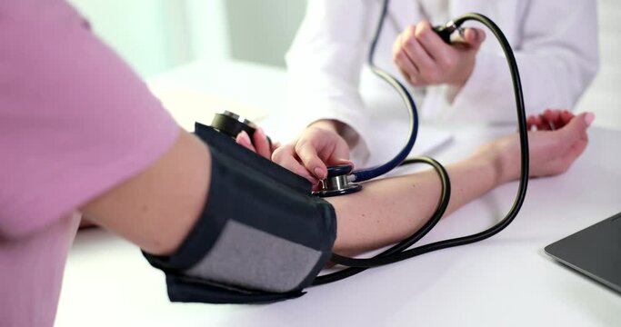 Doctor uses blood pressure monitor to check body pressure and pulse of patients