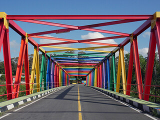 Fototapeta na wymiar Colorful bridge in the middle of the rainforest in Indonesia
