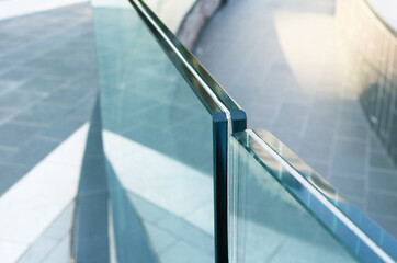 Closeup frameless laminated glass railing for exterior installation.