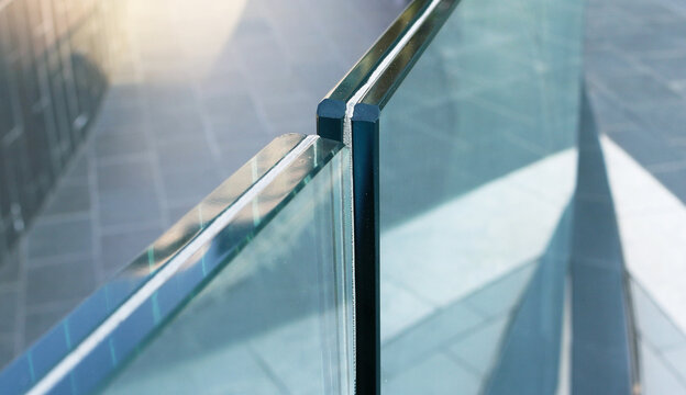 Closeup frameless laminated glass railing outdoor.	
