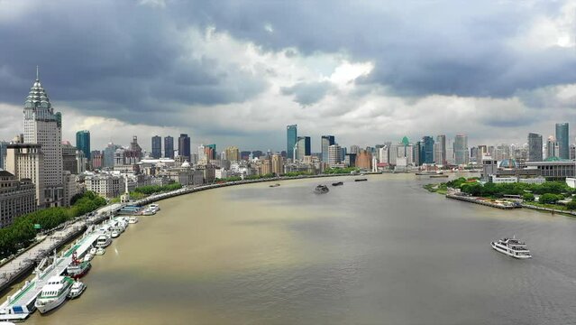Aerial Beautiful View Of Modern Buildings In City, Drone Flying Forward Over River Under Clouds - Shanghai, China