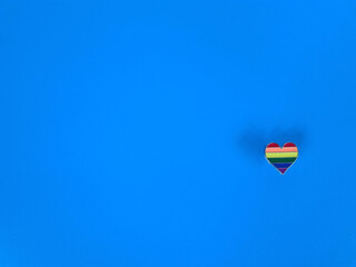 Rainbow ribbons sign symbolize gay and LGBT pride on blue background.