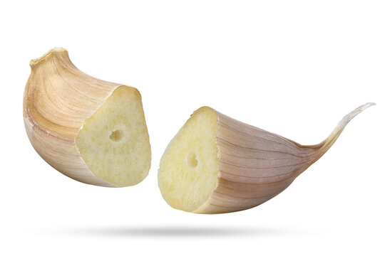 Two halves of a raw garlic segment. Close-up, isolated on white.
