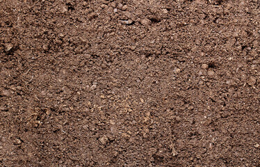 Abstract background. The surface of black fertile land for agriculture with the addition of peat