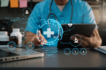 Doctor work on digital tablet healthcare doctor technology tablet using computer in a modern office  in the morning at the desk.