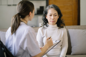 Fototapeta premium Stressed senior old patient are treated by a psychologist or psychiatrist in a psychiatric clinic or hospital. Patients reported symptoms of depression, stress, irritability, and life problems.