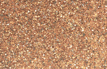 Abstract blurred background of small pebbles in orange and brown