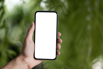 Man holding smartphone with blank screen, close-up of hands. Space for text and blur inside...