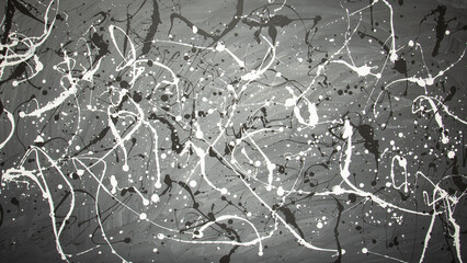 Abstract gray vignetted background with chaotically arranged spots and jets of white paint