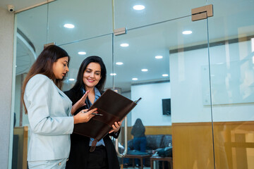 Two indian Corporate woman working with together at office