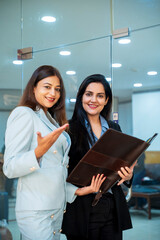 Two indian Corporate woman working with together at office