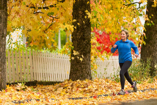 Young woman running in fall