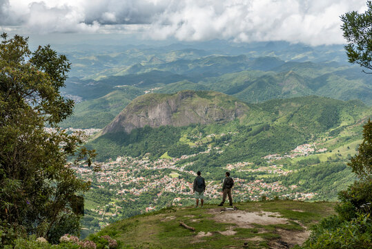Two people on panoramic point looking at valley and mountainous scenery