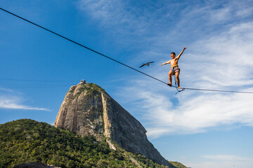 Man spreads ares wide while highlining in Contos De Pescadores, Vermelha Beach, Rio de Janeiro, Brazil