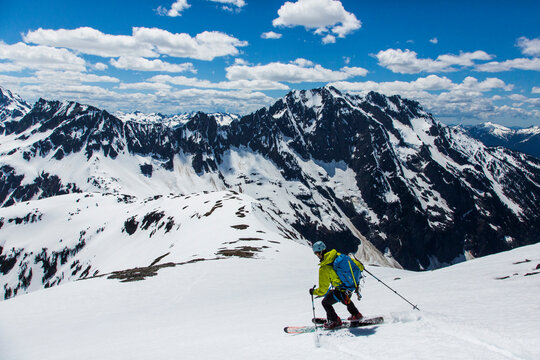 Man skiing down slope of Sahale Peak, North Cascades National Park, Washington State, USA