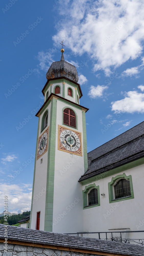 Wall mural San Cassiano, Alta Badia, Italy. The church in the center of the town. Typical Tyrolean architecture. The building dates back to 1782. Tourists attraction. Summer time