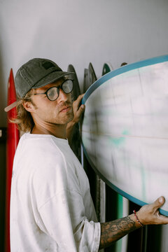Man choosing a surfboard in a surfboard shop