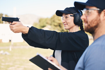 Gun range, target practice and woman holding a rifle for safety, security and police training....