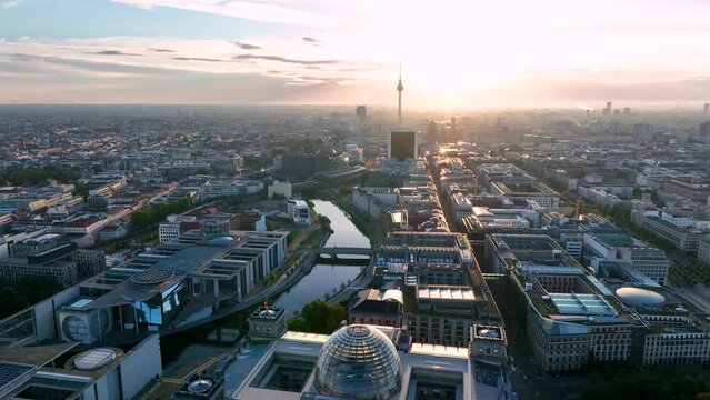 City of Berlin, Germany from above. Aerial cityscape view showing architectural landmarks Reichstag, TV Tower and Berlin Cathedral at sunrise. Drone flight to Alexanderplatz TV Tower, Sunflairs approx