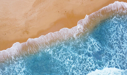 Aerial view of the ocean coast and sandy sea beach. Beautiful water background texture for tourism and advertising. Tropical coast