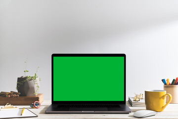 Chroma keChroma key green screen laptop on table with creative, drawing equipment green screen...