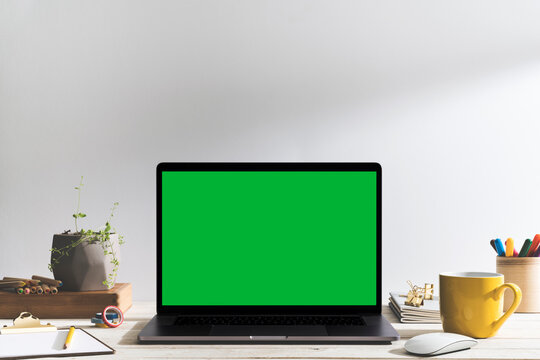 Chroma keChroma key green screen laptop on table with creative, drawing equipment green screen laptop on table. - Powered by Adobe