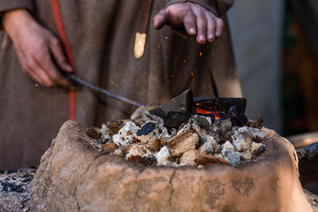 Moscow seasons. Traditional craft. The work of a blacksmith with metal at the celebration of Maslenitsa (Maslenitsa Week). Russian traditions. Tverskaya Street. Moscow. Russia