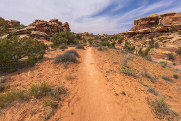 hiking the chesler park loop trail in the needles in canyonlands national park, usa