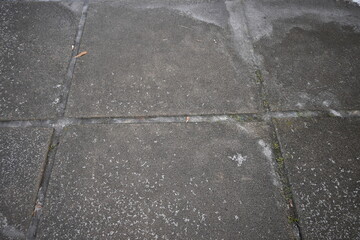 asphalt soviet square concrete tile, asphalt tile covered with thin ice crust, icy ice tile,...