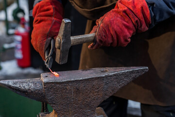 Moscow seasons. Traditional craft. The work of a blacksmith with metal at the celebration of...