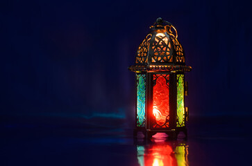 Lantern puts on table with dark blue background for the Muslim feast of the holy month of Ramadan Kareem.