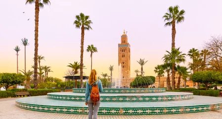 Zelfklevend Fotobehang Woman looking at Koutoubia mosque minaret-Tourism in Marrakech, Morocco © M.studio