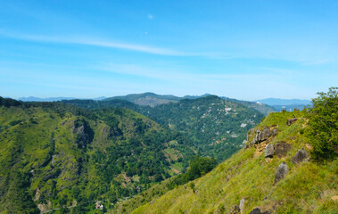 Aerial view of the green hills and gorge. Beautiful mountain background texture for tourism and advertising. Tropical landscape from a drone