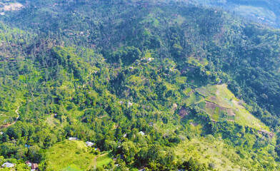 Fototapeta premium Aerial view of the green hills and gorge. Beautiful mountain background texture for tourism and advertising. Tropical landscape from a drone