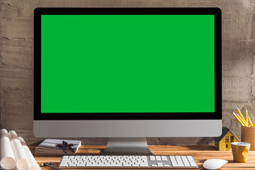 Chroma key green screen computer on table with architectural equipment