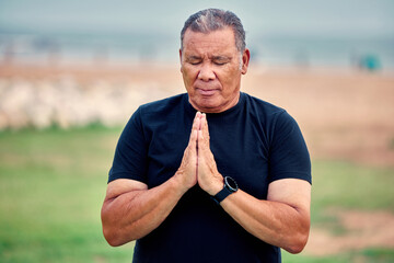 Yoga meditation, senior man and outdoor fitness for pilates wellness, mental health or chakra energy exercise. Elderly male meditate in nature to relax for peace, healing mindset or zen namaste hands