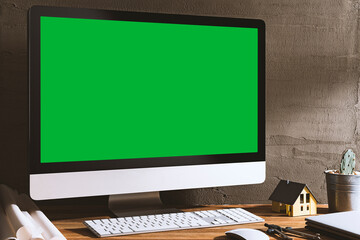 Chroma key green screen, angled view computer on table with architectural equipment