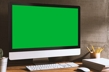 Chroma key green screen computer on table.