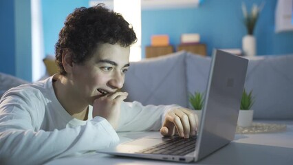 Excited and happy teenager texting on social media. Communication, message.
Sympathetic and handsome adolescent male is chatting on social media with his virtual friend from his laptop at home.
