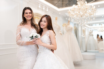 Naklejka premium Portrait caucasian and Asia bride or two bride at modern wedding salon 
