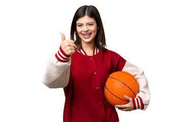 Young Russian woman playing basketball over isolated chroma key background with thumbs up because something good has happened