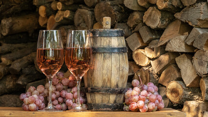 Rose wine in the wineglass and ripe grapes on wooden table. Grape harvest. Wine tasting culture. Sommelier pouring dessert wine in glass. Winery