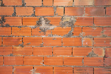 Red brick wall texture of a construction or a construction site.