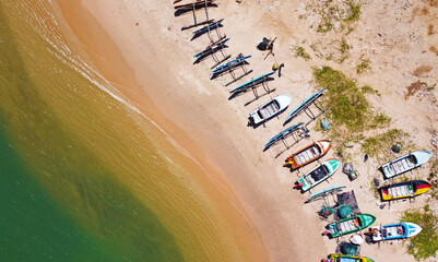 Aerial view of colorful fishing boats on the ocean. Beautiful Asian texture background for tourism and advertising. Tropical landscape from a drone
